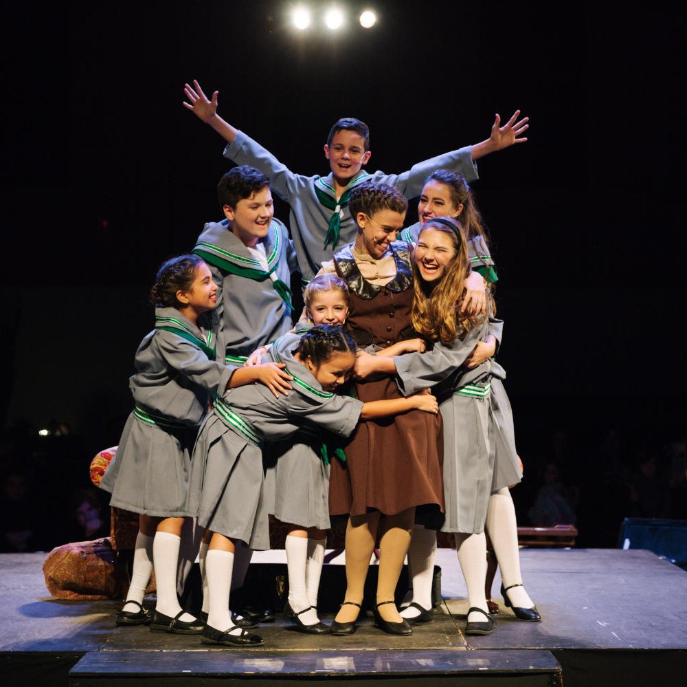Sound of Music Cast hugging on stage
